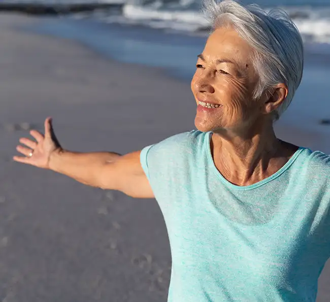 senior-caucasian-woman-enjoying-time-at-the-beach