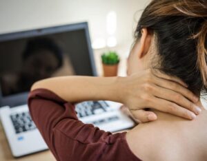 woman holding neck